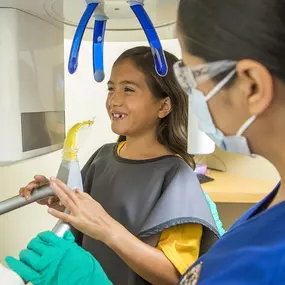A girl gets ready for dental x-rays at dental depot