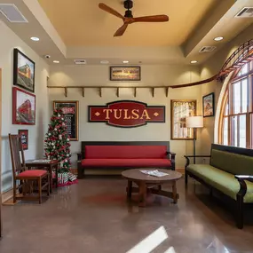 Tulsa Hills dental clinic waiting room and reception area with train themed signage and red furniture
