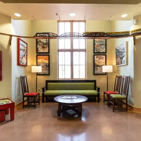 Tulsa Hills dental clinic waiting room and reception area with train themed signage and a model train running around the top of the room.