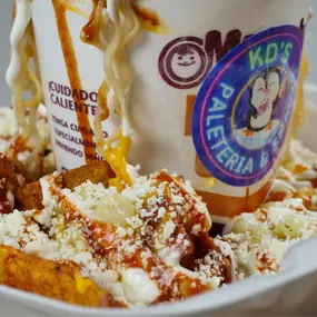 Spilled Maruchan, with cream sauce, your favorite chips, corn, fresh cheese, and yellow cheese.

Maruchan chorreada, con crema, salsa, tus papas favoritas, elote, queso fresco y queso amarillo.