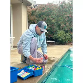 Dialing in the water balance—tech using a Taylor test kit to check and adjust pool chemistry for a safe, sparkling swim.