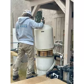 Tech hard at work on a filter cleaning—breaking it down, cleaning it out, and putting it back together for peak performance.