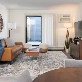 a living room with a couch and a table and a tv