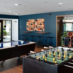 a game room with a foosball table and a video game