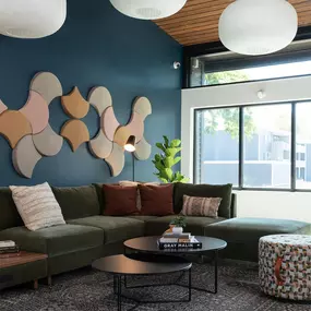 a living room with blue walls and a green couch