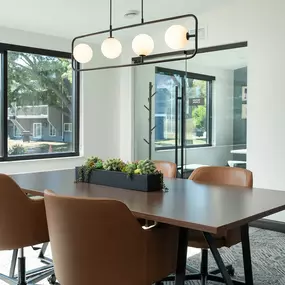 a conference room with a large window and a table with chairs