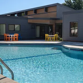 a swimming pool with a house in the background