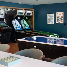 a gaming room with arcade games and tables