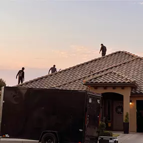 R1 Roofing & Exteriors crew performing tile roof installation in Arizona at sunset
