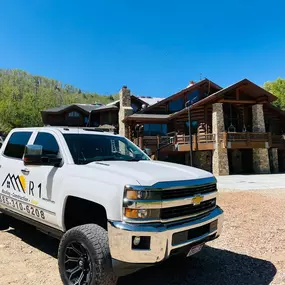 R1 Roofing & Exteriors service vehicle at a high-end roofing project in Arizona