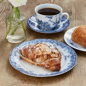 almond croissant and coffee on table