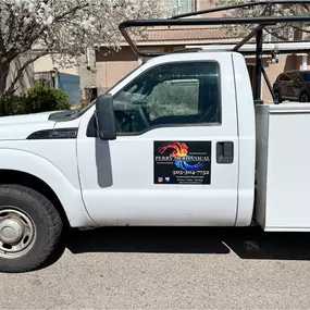 A white Ford F-250 work truck with the Perry Mechanical Inc. logo and contact information on the door, equipped for HVAC and plumbing service calls.