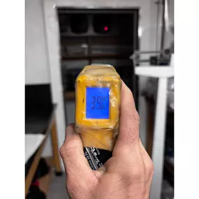 A handheld infrared thermometer displaying a temperature of 39.0°F, likely used by Perry Mechanical Inc. for HVAC diagnostics.