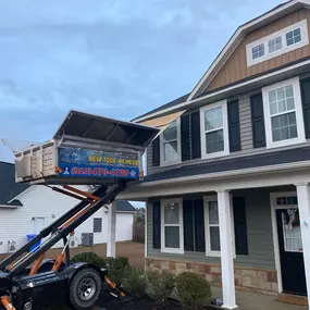 full roof replacement on a house in Fayetteville using the Equipter to protect the first story roof from the shingles being removed from the 2nd story.