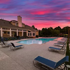 Swimming pool with clubhouse at sunset