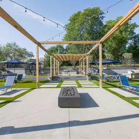 Large patio with lounge chairs and a fire pit