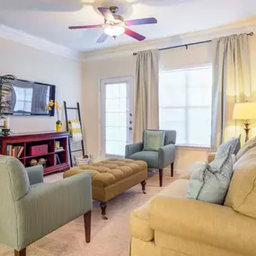 A cozy living room at Grande Club Apartments with warm tones and stylish furnishings.