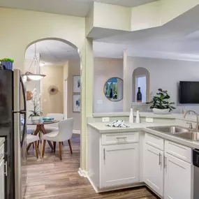 A modern kitchen at Grande Club Apartments with a stylish open-concept layout.