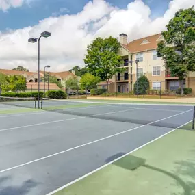 A well-kept tennis court at Grande Club Apartments offers a space for active living.