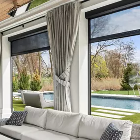 Prep your patio for cooler temps with layered outdoor solutions—elegant drapes paired with motorized shades for comfort, privacy, and style year-round.