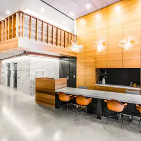 A modern office space with a long table and chairs.