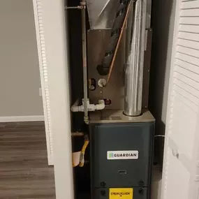 A Guardian HVAC furnace unit is installed in a closet, providing efficient heating and cooling for the indoor space.