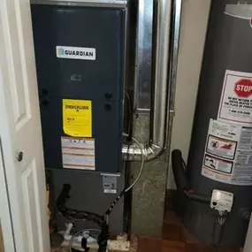 A Guardian furnace and water heater installed in a utility closet, ensuring efficient heating and hot water supply for the home.