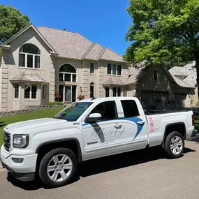 American Eagle Home Improvement company truck outside of residential home with new roof