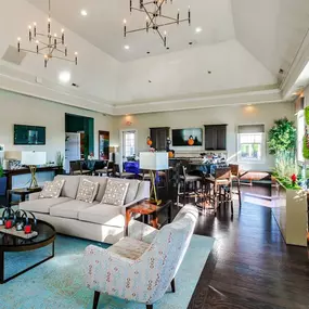A spacious living room with couches and chairs and a dining room with a kitchen