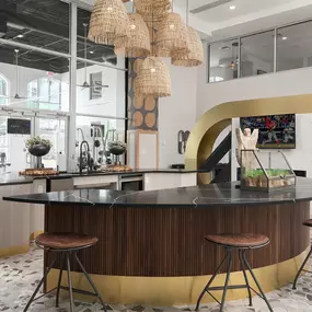 the lobby or reception area of a hotel with a bar and stools
