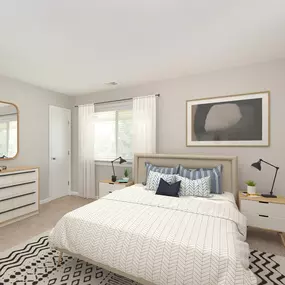 a bedroom with a large bed and a dresser with a mirror on it