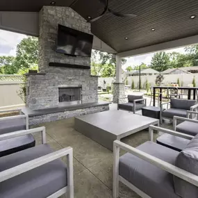 Patio with couches and a fireplace