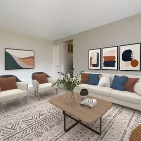 Living room with a couch and two chairs and a table