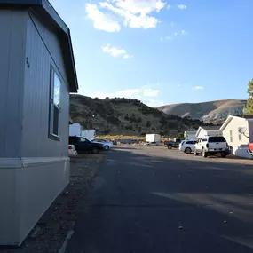 a parking lot in a trailer park with mountains in the background