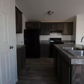 a kitchen with wooden cabinets and a sink