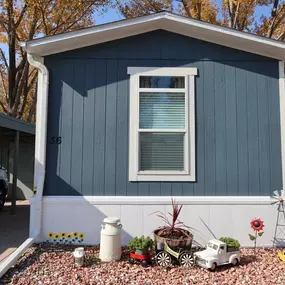 An exterior view of a blue and white mobile home