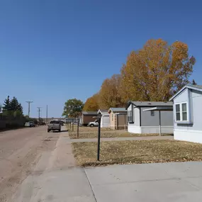 A row of mobile homes on the side of a road.
