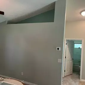 3 Brothers Painting & Home Improvements, LLC transformed this interior with fresh sage green and cream walls, crisp white trim, and clean ceiling lines, enhancing the space with a modern, calming aesthetic.