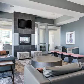 Lounge seating with charging stations and entertainment room.