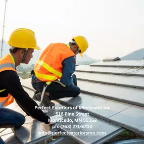 Professional roofing contractors installing metal panels on a residential roof in Minnesota.
