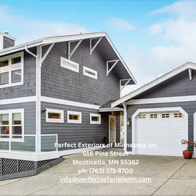 Newly remodeled home exterior featuring modern gray siding, white trim, and a clean concrete driveway.
