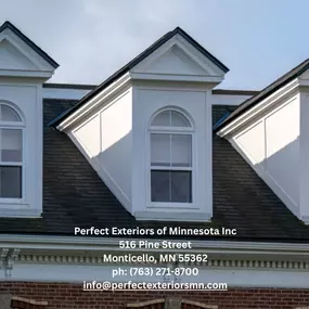 Classic residential roof with asphalt shingles and detailed dormer architecture.