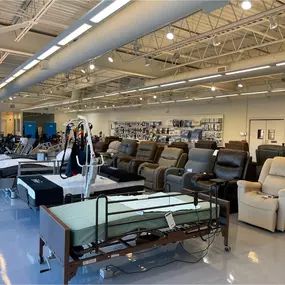 Wide-angle view of hospital beds and reclining chairs, all available for rent or sale at our Elmwood Park medical equipment center.