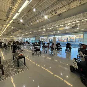 Spacious view of Medfirst Homecare’s showroom featuring scooters, hospital beds, and a full range of durable medical equipment.
