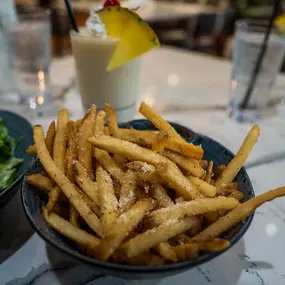 A bowl of French Fries at Reel Food & Drink