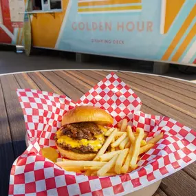The burger and fries at the Golden Hour container bar