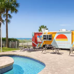 The Golden Pool Bar container bar with the pool and picnic tables