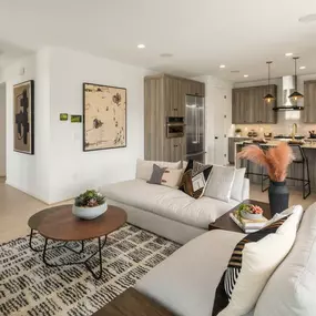 Great room and kitchen of the Tapps home design with a 2-story foyer beyond