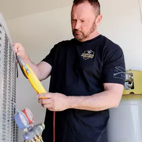 5 Star HVAC Technician Making Repairs to Unit
