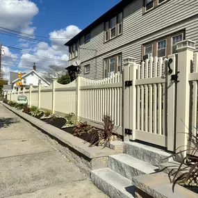 Beige Scalloped Vinyl Fence with GateSolar caps Granite Steps Nicolock Retaining wall and landscaping design by Done Right Landscape & Construction